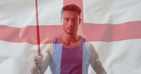 this image depicts a caucasian male javelin athlete confidently posing with the england flag. the blend of national flag and sportsman symbolizes pride and strength in athleticism. perfect for representing themes of national sports enthusiasm, patriotism, and athletic dedication. ideal for sports campaigns, motivational materials, or coverage of international athletics events.