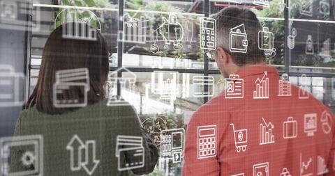 Business Icons Overlay with Colleagues Collaborating in Modern Office