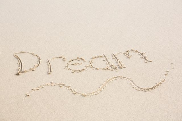 Dream written on sand at beach conveys a sense of relaxation, inspiration, and motivation. Ideal for travel brochures, motivational posters, summer vacation advertisements, and inspirational social media posts.