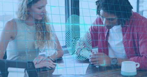 Colleagues reviewing biometric forms with holographic fingerprint overlay in sunlit office