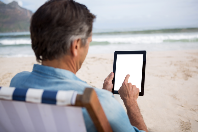 Rear View of Man Using Transparent Tablet on Beach - Download Free Stock Videos Pikwizard.com