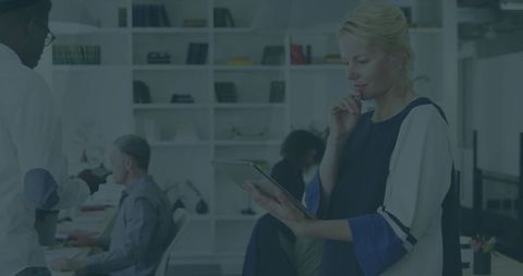 Professional Woman Analyzing Tablet in Modern Office Environment