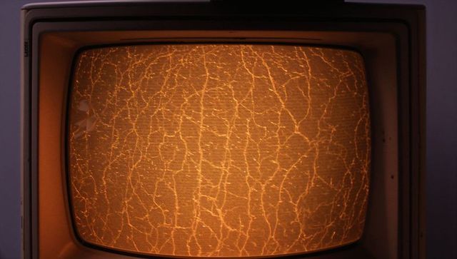 Vintage crt television screen glowing with amber crackle and curved glass bezel retro glow