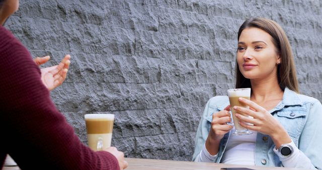 Two Friends Relaxing with Lattes at an Outdoor Cafe - Download Free Stock Images Pikwizard.com