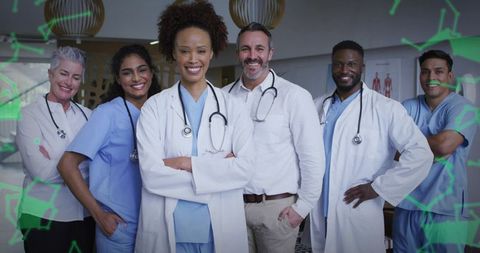 Multidisciplinary medical team standing smiling and collaborating in modern clinic environment