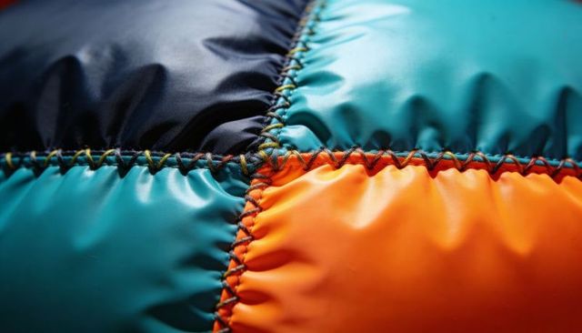Colorful quilted panels featuring zigzag stitching in orange, teal, navy glossy padded fabric