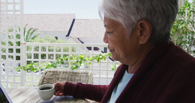 Senior Woman Relaxing with Cup of Coffee on Sunny Balcony - Download Free Stock Images Pikwizard.com