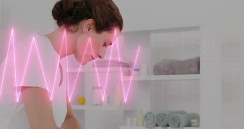 Physiotherapist Assisting with Foot Bandaging and Heart Rate Graphic