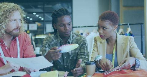 Creative team collaborating in modern workspace with color samples