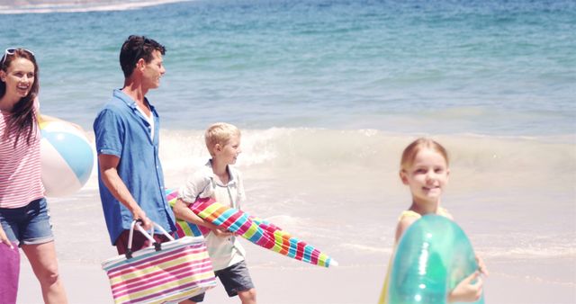 Happy Family Enjoying Day at Beach with Inflatable Toys - Download Free Stock Images Pikwizard.com