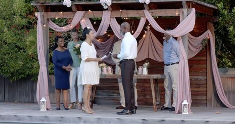 Senior Couple Exchanging Vows in Intimate Garden Ceremony