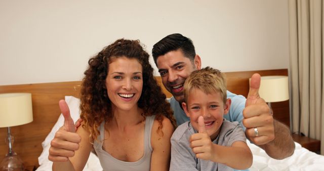 Happy Family Relaxing in Bed With Thumbs Up - Download Free Stock Images Pikwizard.com