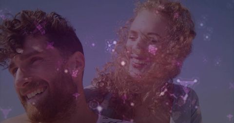 Romantic Couple Enjoying Vibrant Beach Day with Glowing Stars