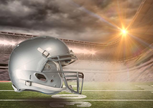 Football helmet positioned on a stadium field under dramatic lighting conditions with a sunset in the background. Ideal for use in sports promotions, football season campaigns, athletic event advertisements, and team gear marketing materials.