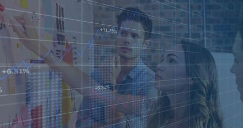 Collaborative business team analyzing data on whiteboard with rising charts overlay
