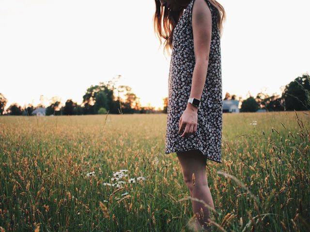 Woman Standing in Field at Sunset Wearing Floral Dress - Download Free Stock Photos Pikwizard.com
