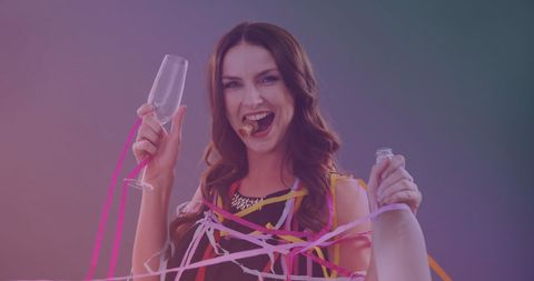 Smiling Woman Dancing with Champagne at Festive Party