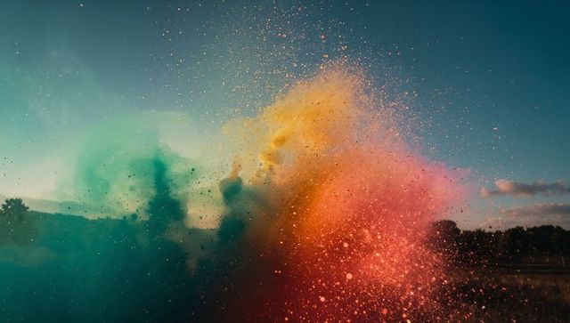 Vibrant color powder explosion at sunset