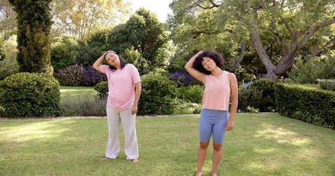 mother and daughter stretch neck outdoors in garden - Download Free Stock Images Pikwizard.com