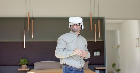Man experiencing virtual reality in stylish bedroom