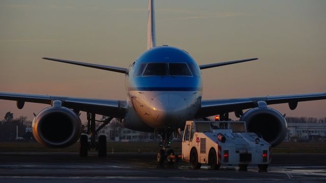 Commercial Airplane Being Towed by Pushback Vehicle at Dawn - Download Free Stock Photos Pikwizard.com