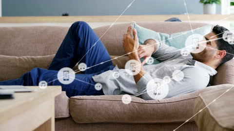 Man Relaxing on Sofa Connecting with Social Media Network