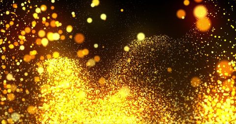 Vibrant golden particles on black background