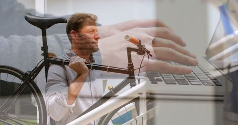 Businessman Holding Bike Overlaid with Laptop Typing Concept - Download Free Stock Images Pikwizard.com