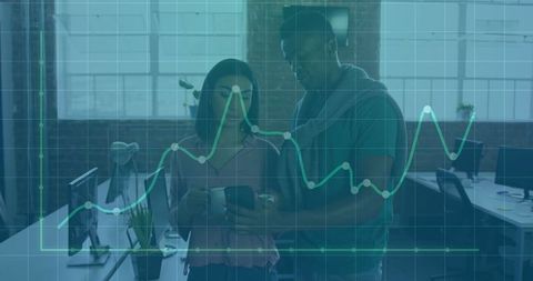Colleagues Analyzing Data with Overlayed Graph in Modern Office