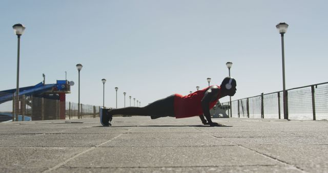 Man Exercising with Push-Ups on Waterfront Promenade - Download Free Stock Images Pikwizard.com