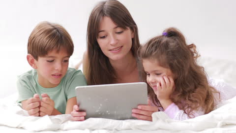 Mother and Children Engaging with Tablet Device at Home