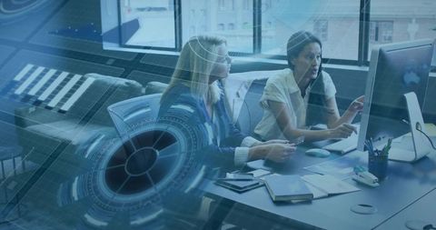 Businesswomen Collaborating with Digital Technology Interface in Office