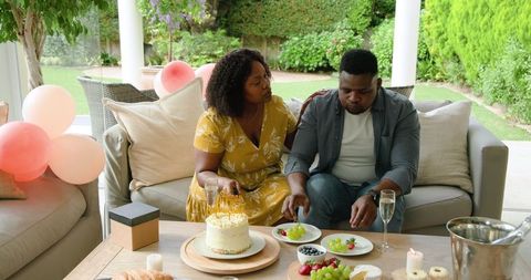 Joyful Celebration with Cake on Outdoor Patio