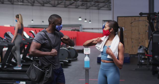 Fitness Enthusiasts Greeting with Elbow Bump in Gym Wearing Masks - Download Free Stock Images Pikwizard.com