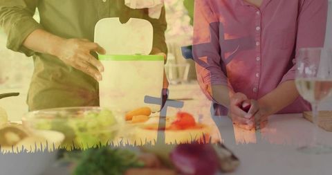 Couple preparing meal with sunset cross silhouettes double exposure warm kitchen scene