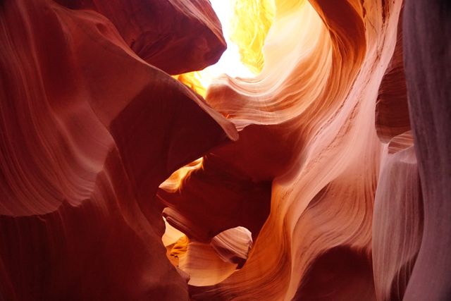Antelope Canyon's intricate sandstone formations, illuminated by sunlight, creating a magical natural landscape. Perfect for use in travel brochures, nature magazines, or websites promoting tourism and natural wonders. Ideal for background images that evoke a sense of adventure and awe.