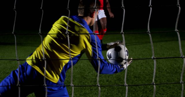 Goalkeeper Catching Soccer Ball During Night Match - Download Free Stock Images Pikwizard.com