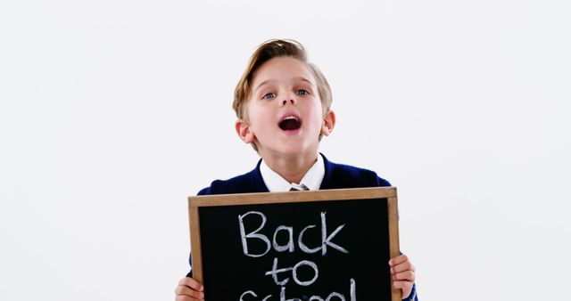 Excited Boy Holding Back to School Chalkboard - Download Free Stock Images Pikwizard.com