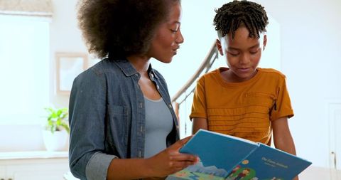 Mother and son reading together in cozy home environment