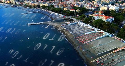 Aerial coastal resort with binary overlay suggesting smart beach connectivity and digital tourism