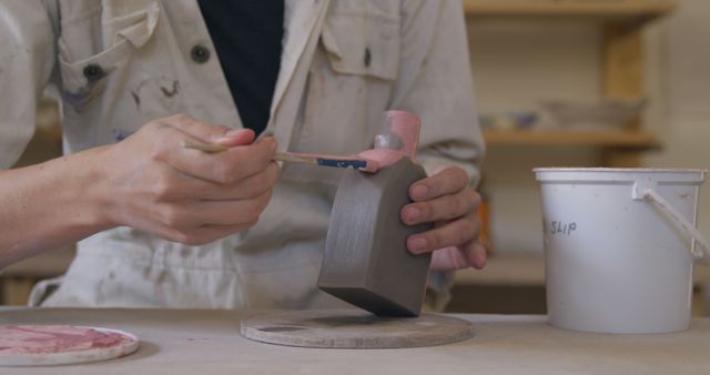 Potter Applying Pink Glaze to Ceramic Vase in Studio - Download Free Stock Images Pikwizard.com