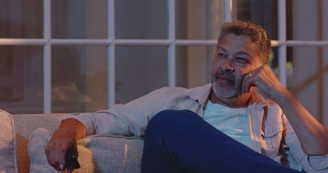 Senior Man Enjoying Comfortable Evening on Sofa at Home