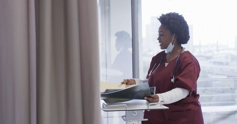Female Doctor Reviewing X-Ray Images in Modern Hospital Setting