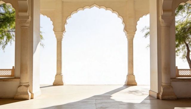 Sunlit scalloped arch colonnade framing minimal stone courtyard with slender columns
