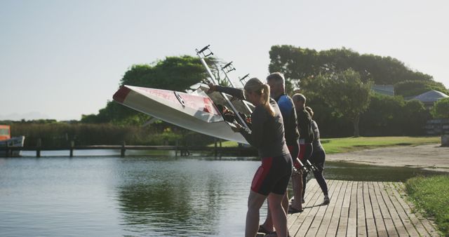 Team of Rowers Preparing Boat on Riverbank - Download Free Stock Images Pikwizard.com