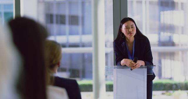 Asian Businesswoman Engaged at Podium During Conference Q&A Session - Download Free Stock Images Pikwizard.com