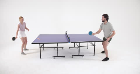 Energetic Table Tennis Match in Modern Studio