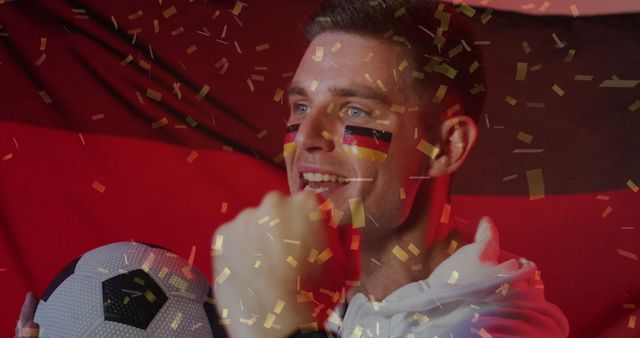 Excited German Soccer Fan Celebrating Victory with Flag and Confetti - Download Free Stock Images Pikwizard.com