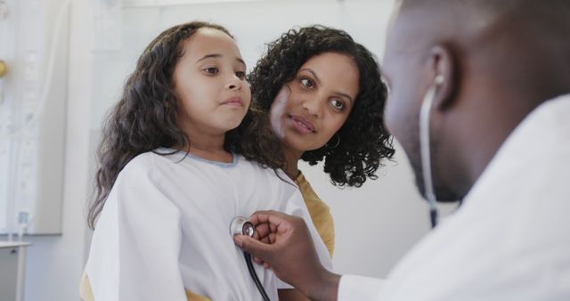 Doctor Examining Child Using Stethoscope with Concerned Parent Nearby - Download Free Stock Images Pikwizard.com