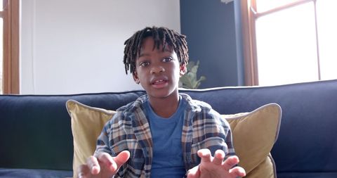 African American Boy Video Calling at Home on Sofa